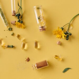 Herbal Capsules and Powder on Yellow Surface